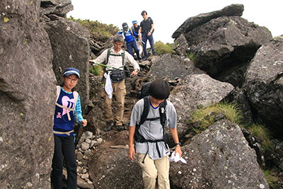 硫黄岳山頂直下の岩場を下っている写真