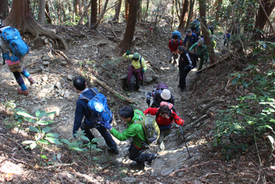 岩のある登山道を登ってくる２班のメンバーの写真